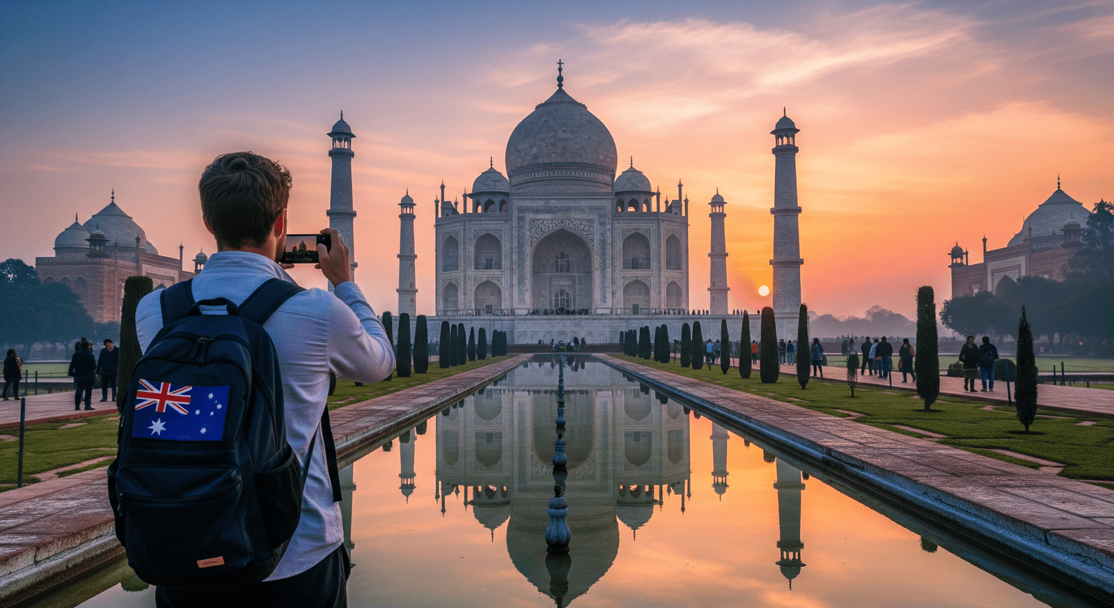 Australian tourist admiring the Taj Mahal at sunrise in Agra, India — soft golden light reflecting on the marble monument.