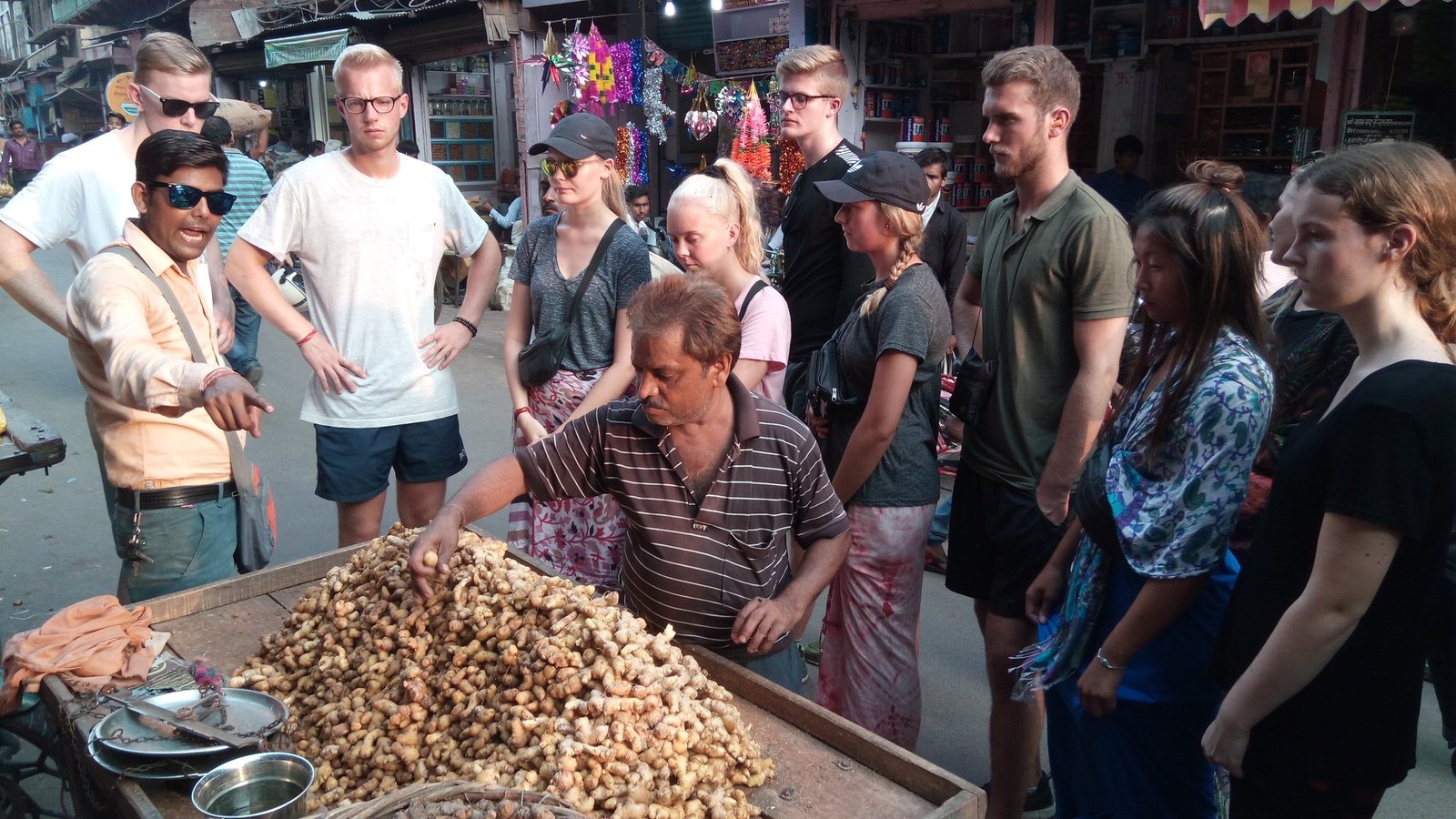 Foreign tourists walking in Agra local market exploring streets near Taj Mahal
