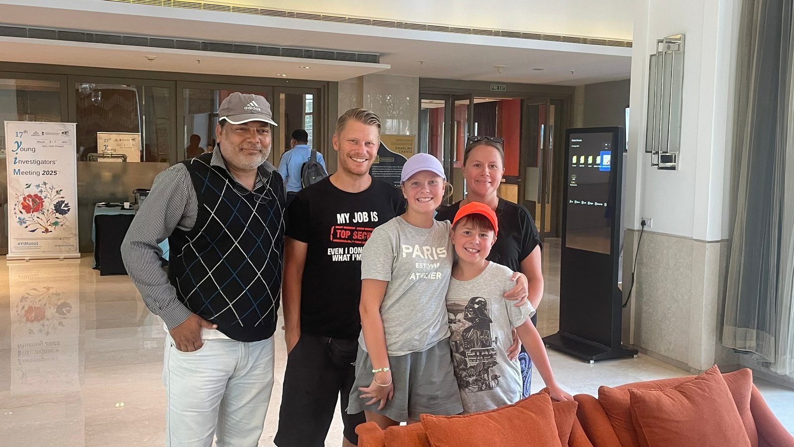 Agra Travel Guide - Taj Mahal tour expert Babloo with a happy foreign family at an Agra hotel before their sightseeing tour