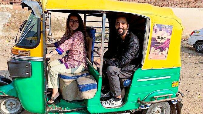 Auto rickshaw and tuk tuk at Agra Cantt Railway Station with international tourists exploring local transport in Agra