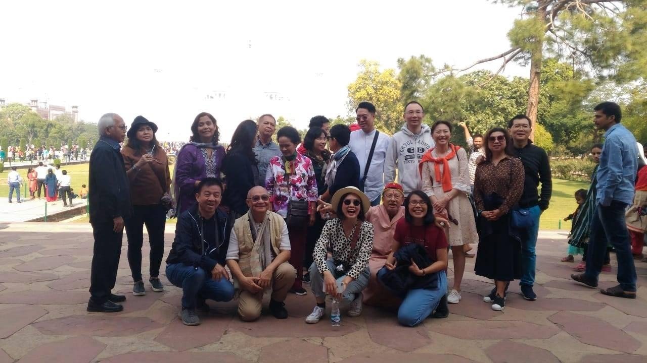 Group of tourists walking and enjoying the garden view of the Taj Mahal during a visit on 26 January Republic Day.