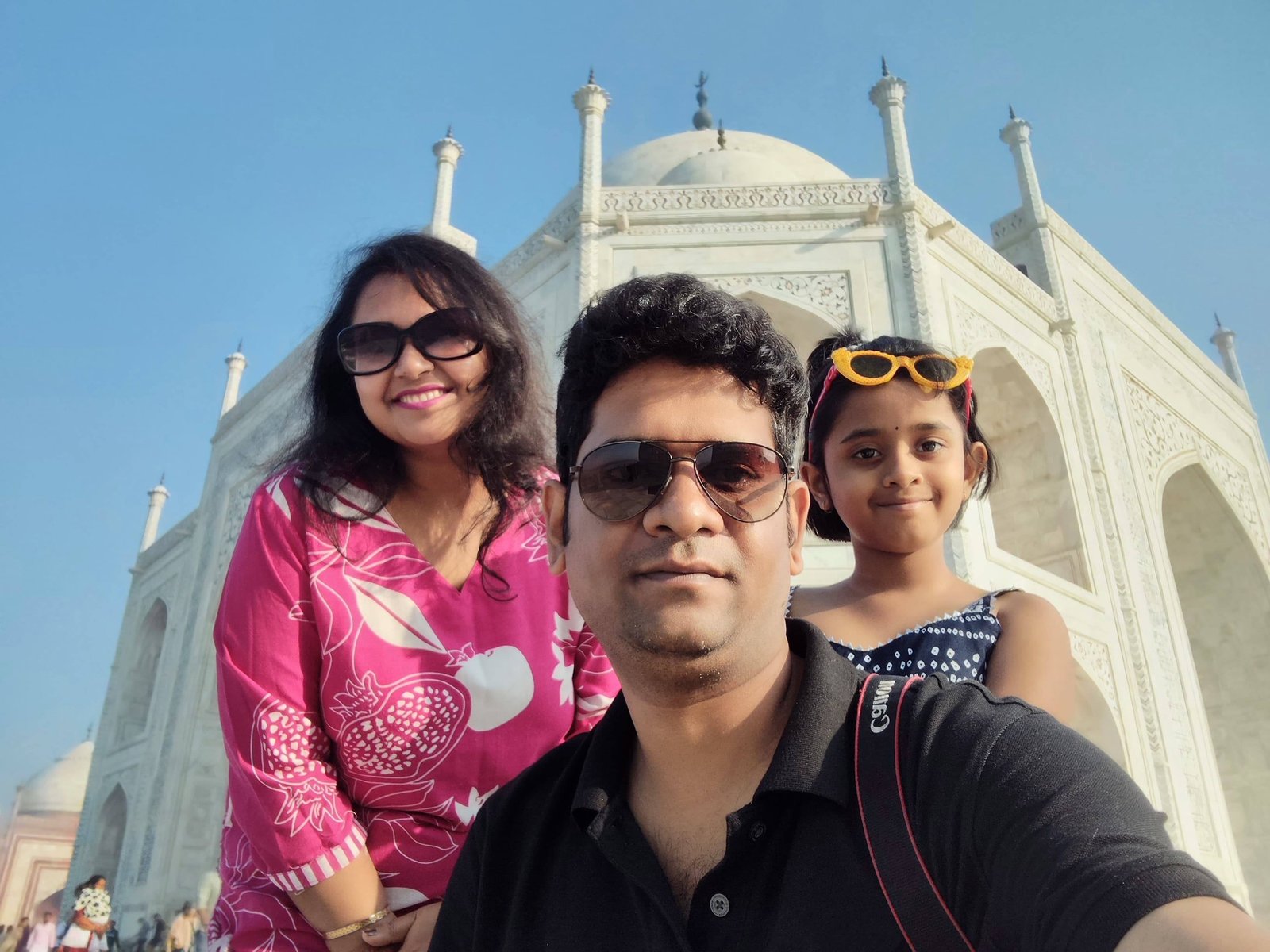 Family enjoying the Taj Mahal during free entry day with crowds in the background